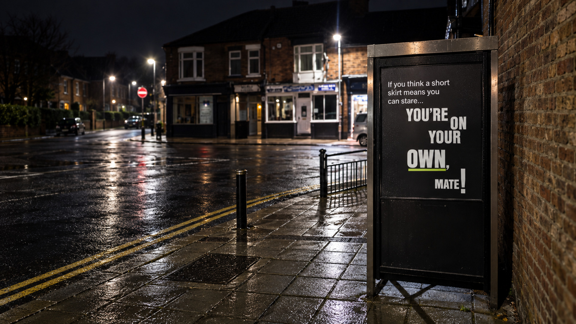 Safer Streets phone-kiosk poster on a wet Darlington street at night, reading If you think a short skirt means you can stare... You're on your own, mate!