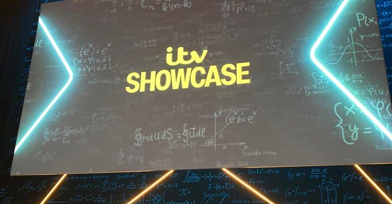 A board illuminated with neon lights displaying the text 'ITV showcase'