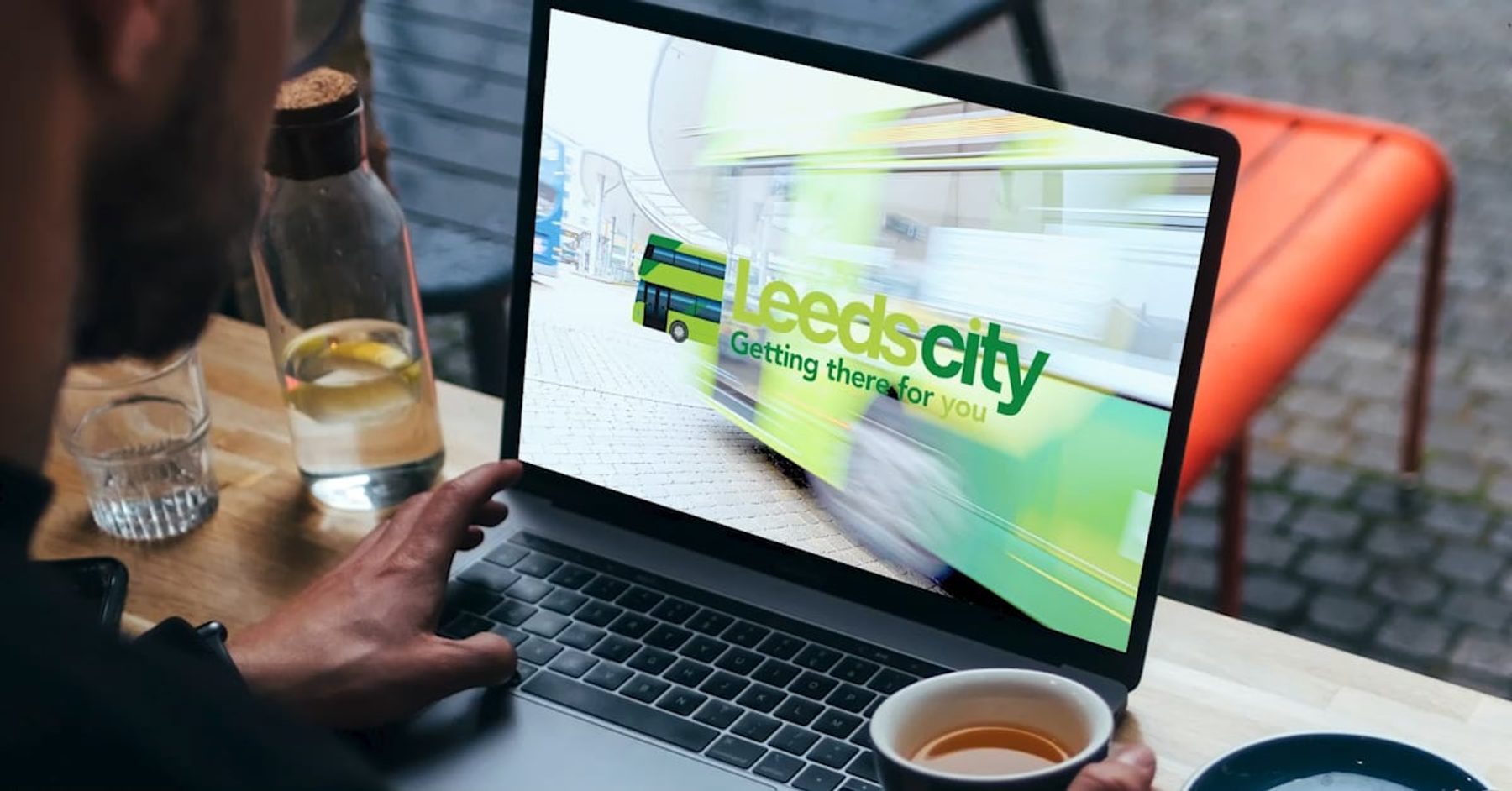 A laptop screen featuring Leeds City’s ‘Get There for You’ campaign, displaying a bus in the background