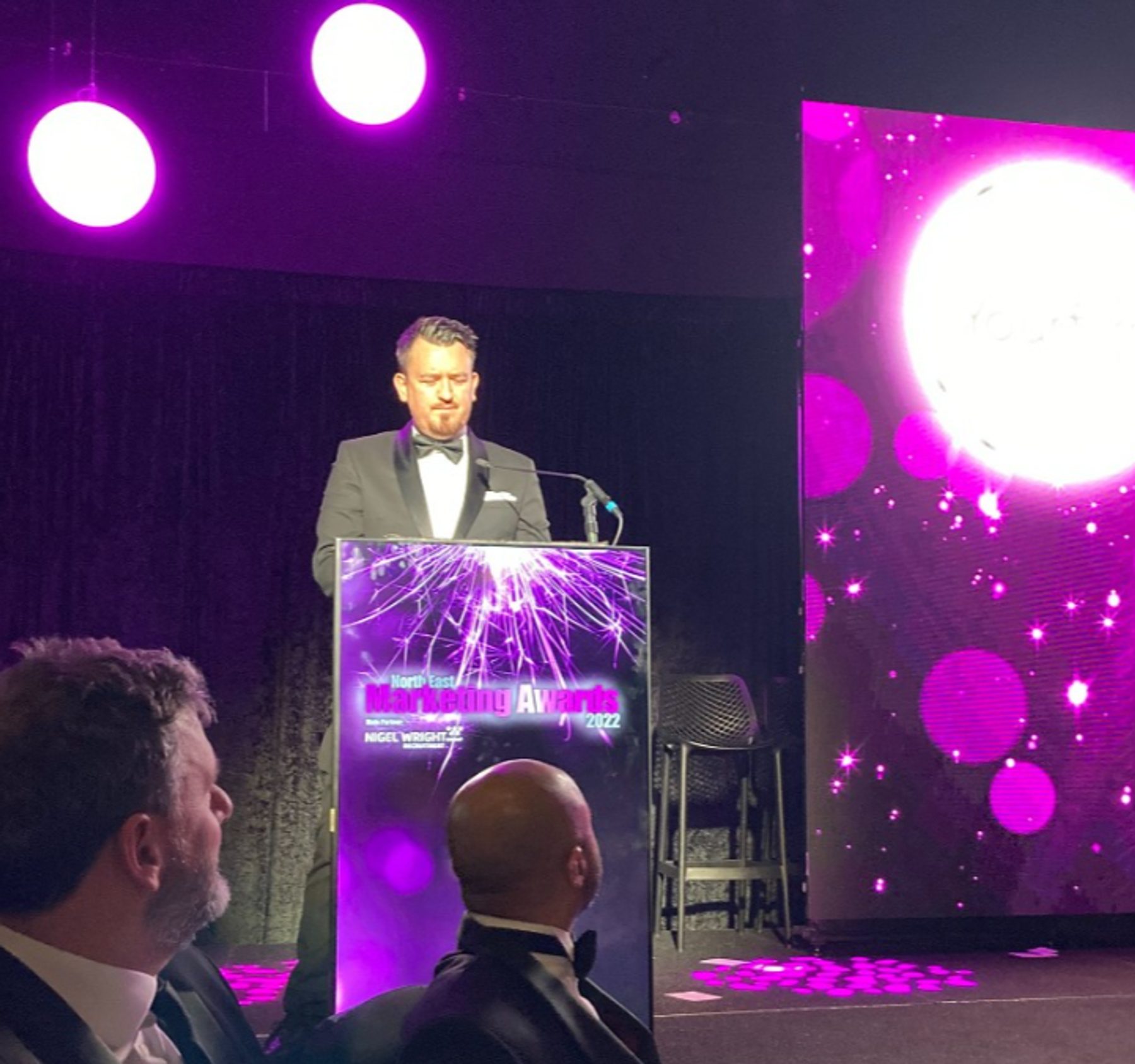 A speaker presenting from the lectern at the North East Marketing Awards